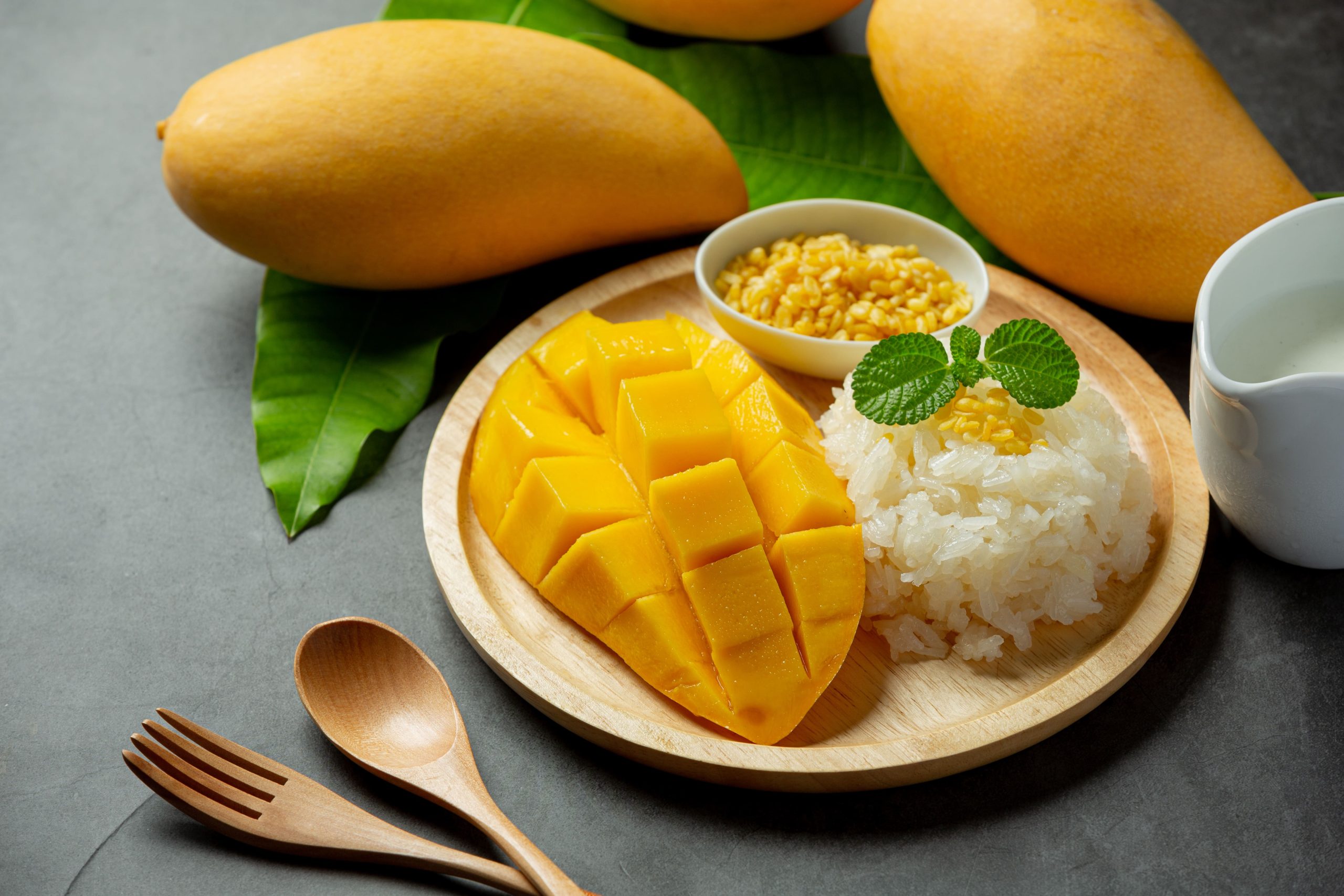 fresh-ripe-mango-sticky-rice-with-coconut-milk-dark-surface